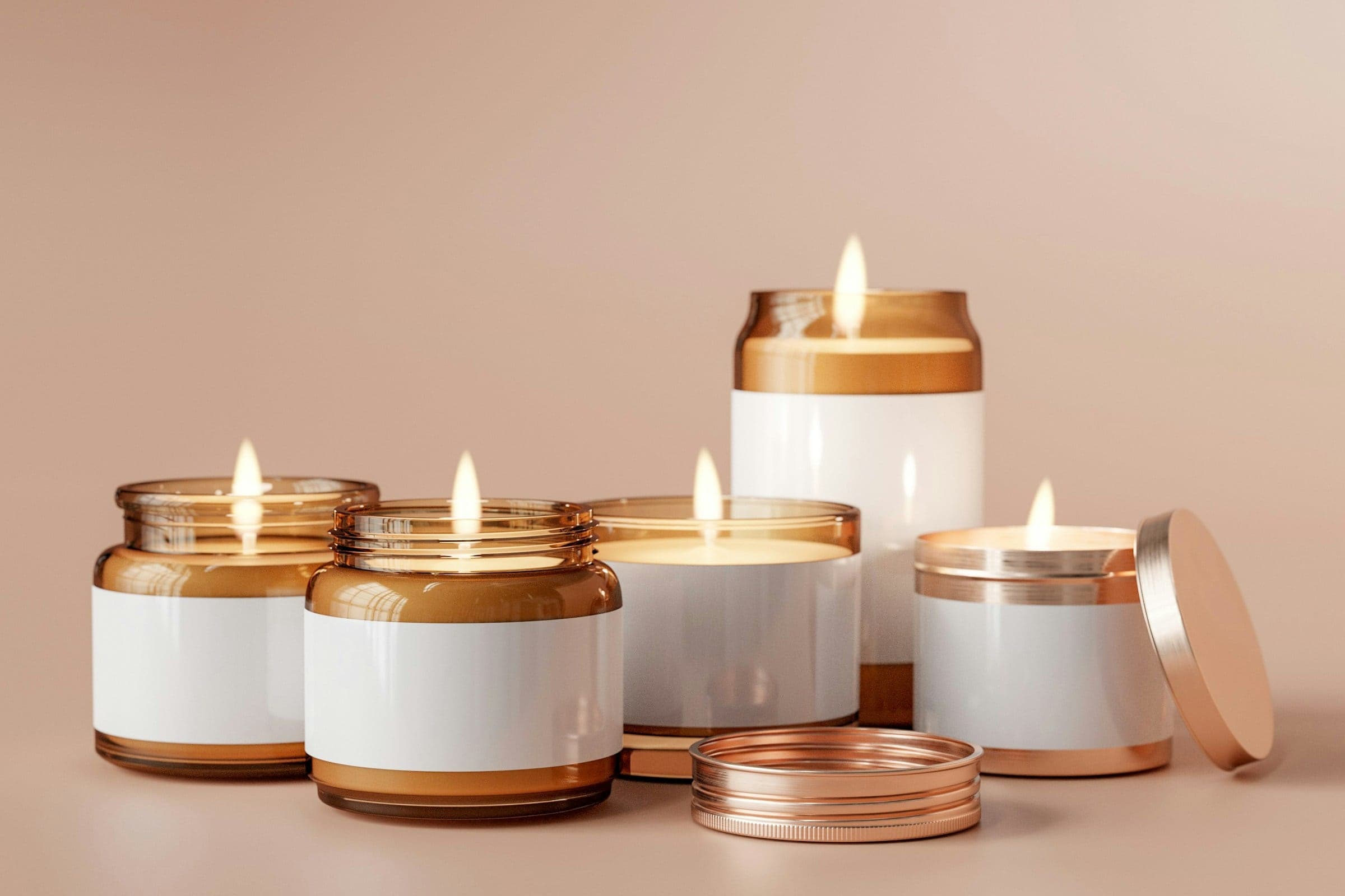 A group of candles in amber and white jars with copper lids