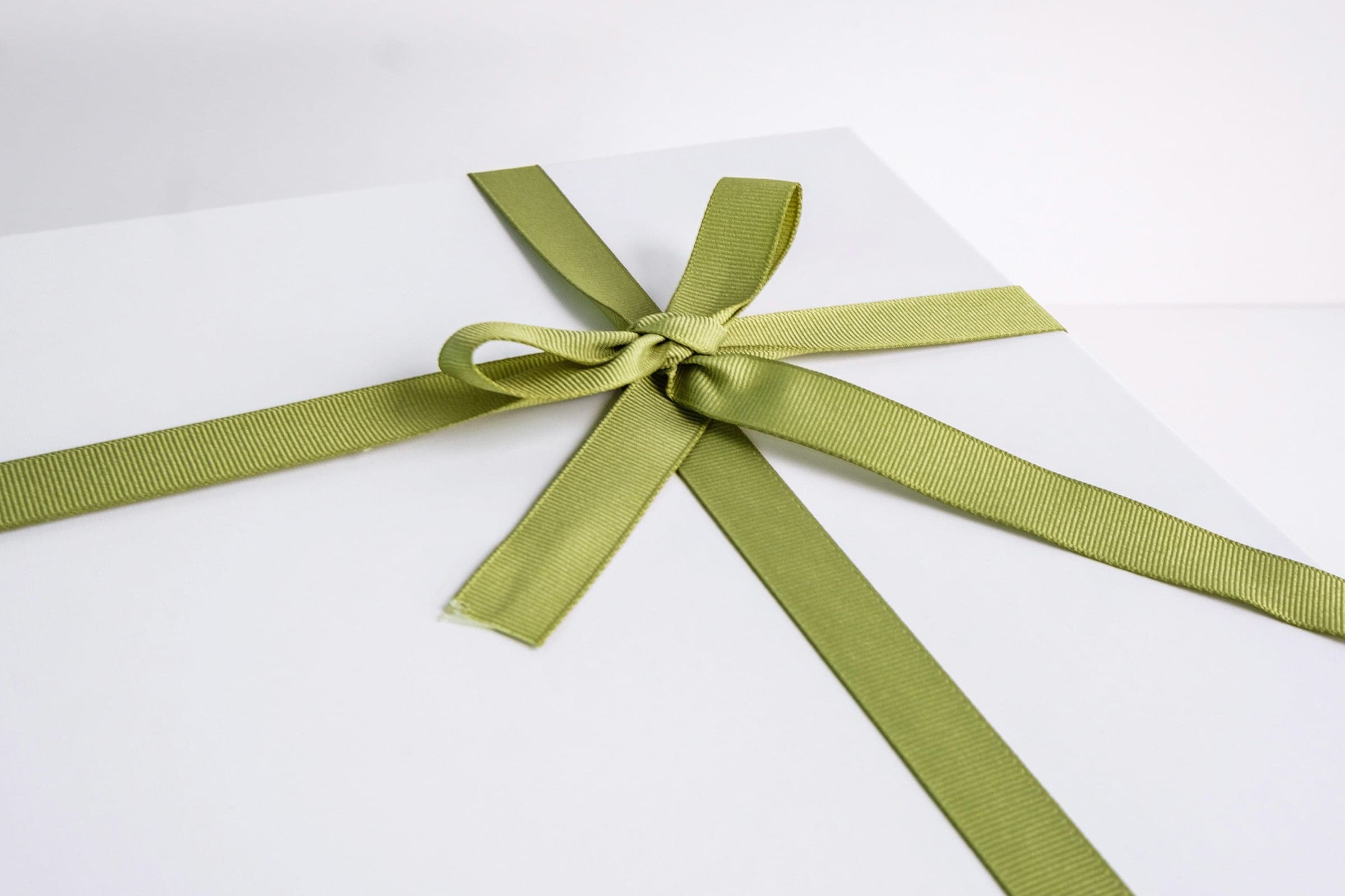 A white box tied with green ribbon