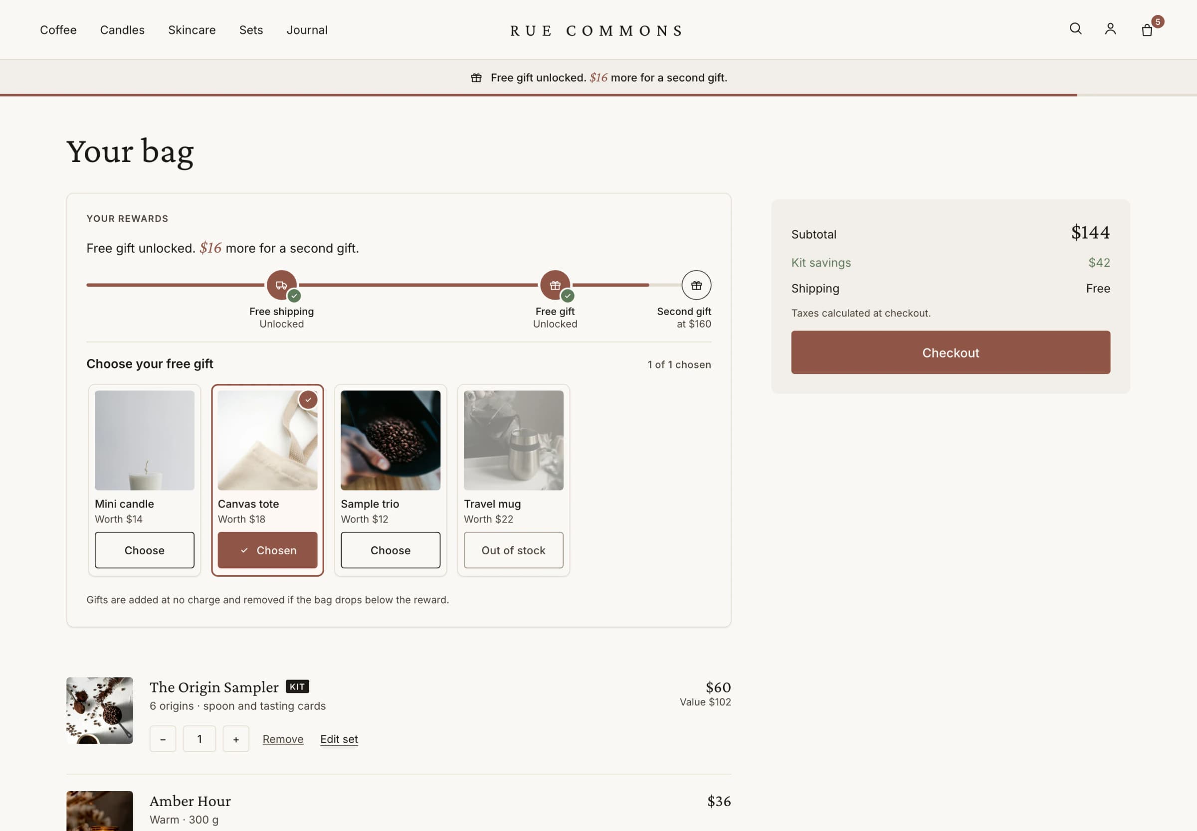 Theme cart page with the Luxe rewards bar and gift picker: free shipping and a free gift unlocked, $16 more for a second gift, canvas tote chosen