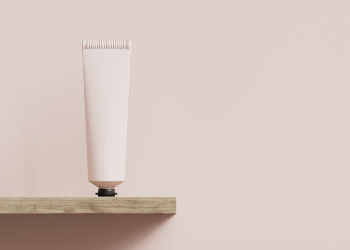 A tube of balm on a wooden shelf